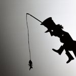 shadow play featuring poor hobo and skeleton of fish